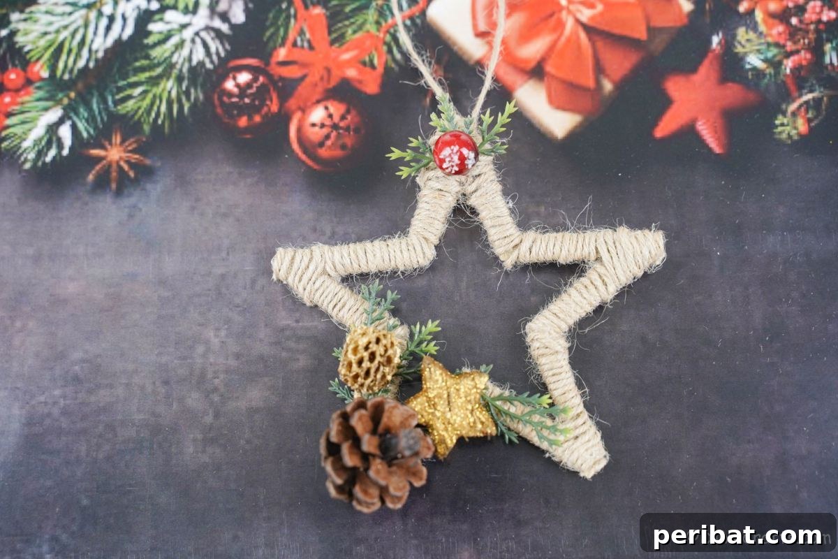 A finished twine Christmas star ornament resting on a black textured surface.