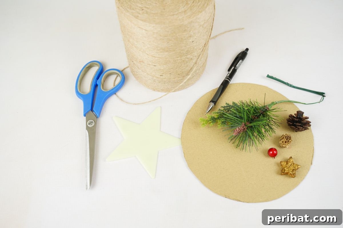 Essential crafting supplies including cardboard, twine, greenery, and blue scissors laid out on a clean white table.