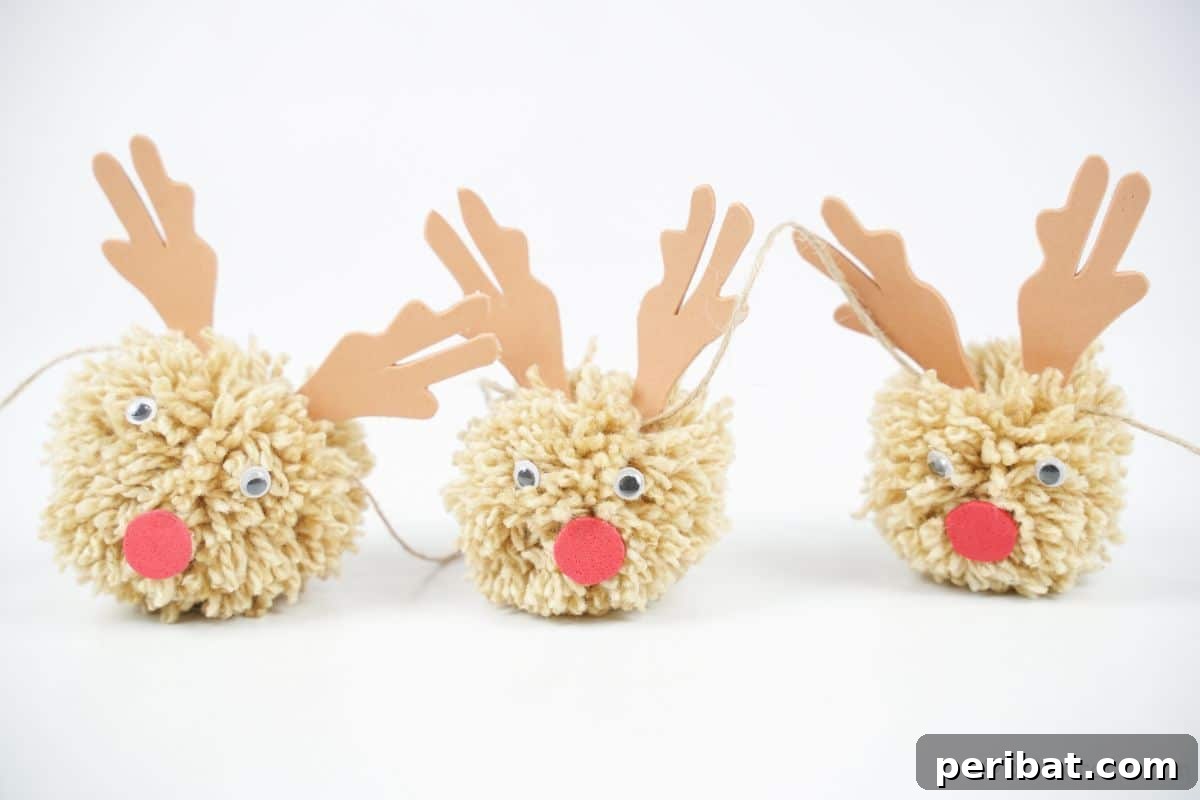 Festive Fluffy Reindeer Christmas Garland Craft 17 A completed reindeer garland resting on a white table, showcasing the finished craft