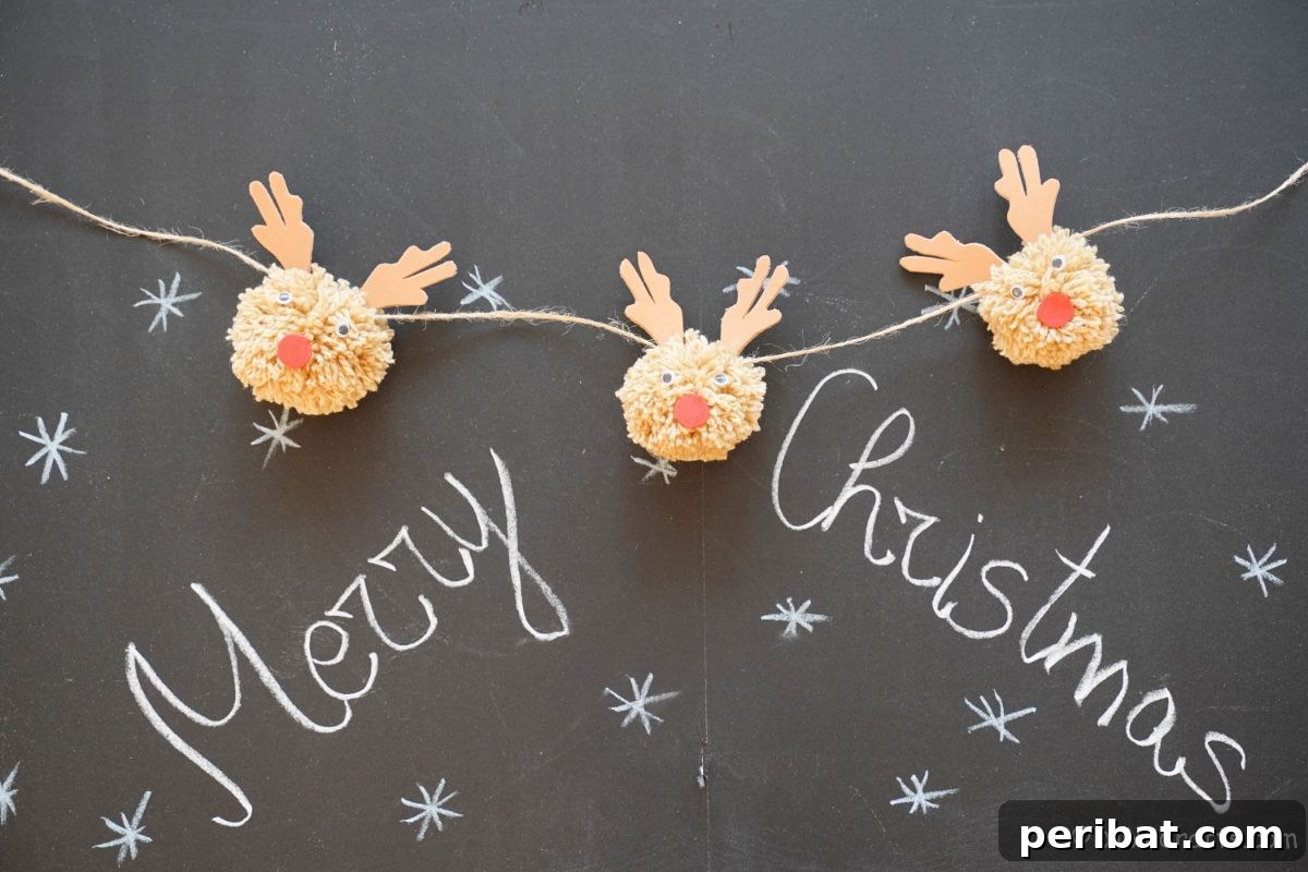 Festive Fluffy Reindeer Christmas Garland Craft 3 Three handmade pom pom reindeer on twine hanging over a chalkboard with a 'Merry Christmas' message