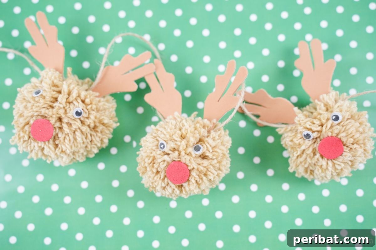 Festive Fluffy Reindeer Christmas Garland Craft 5 A pom pom reindeer garland displayed on light green and white polka dot paper