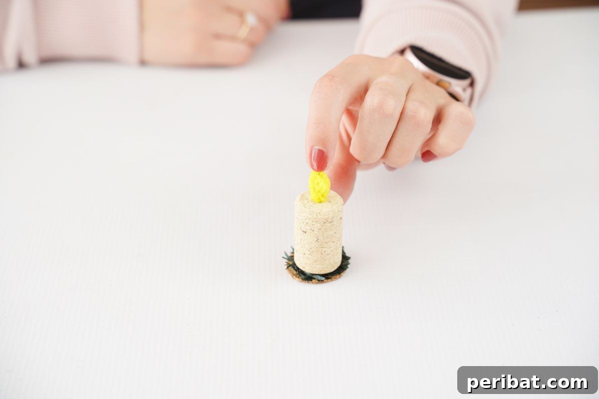 Crafted Wine Cork Candle Accents 13 finger on top of yellow pipe cleaner flame on wine cork