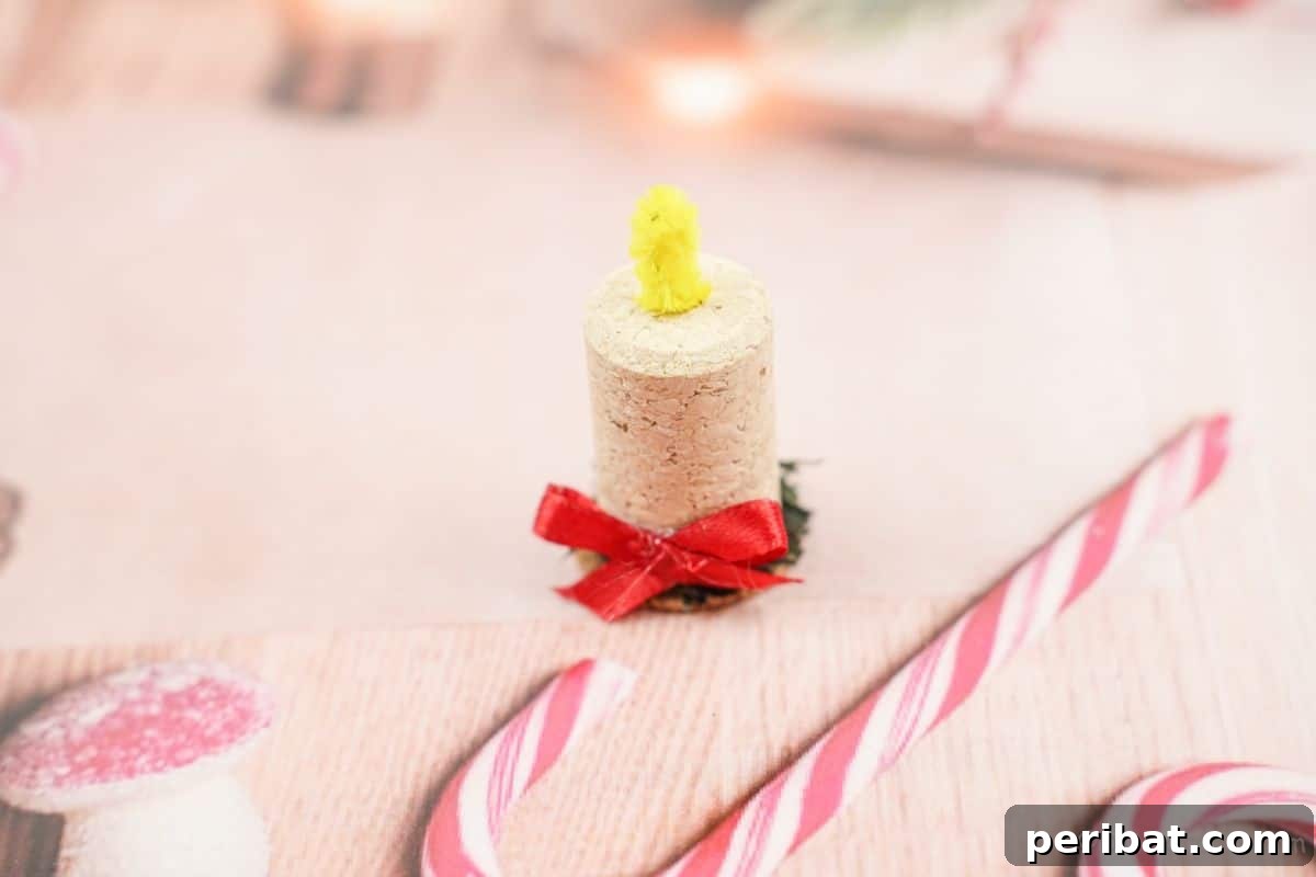Crafted Wine Cork Candle Accents 5 wine cork holiday ornament on pink paper with candy cane