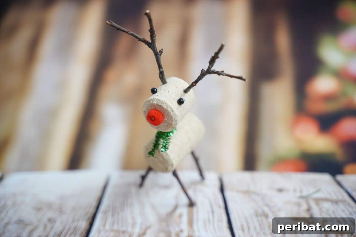 Whimsical Wine Cork Reindeer Ornament 3 A charming wine cork reindeer ornament sits on a rustic wooden table, ready to be a part of any festive holiday display.