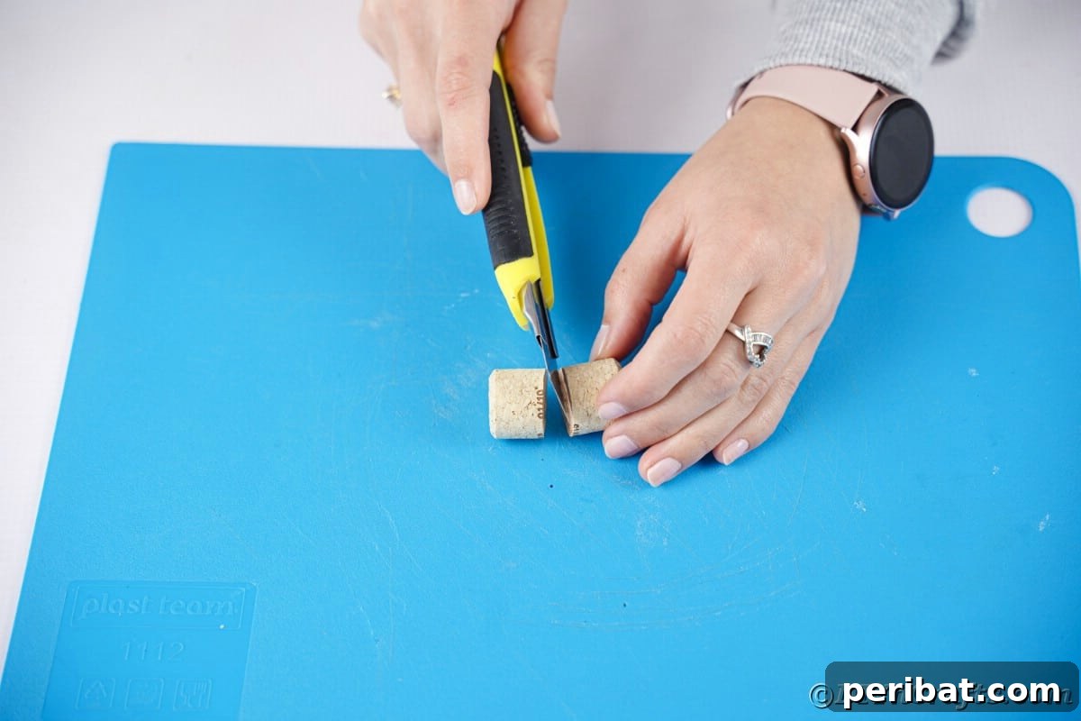 hand using craft knife to cut cork in half
