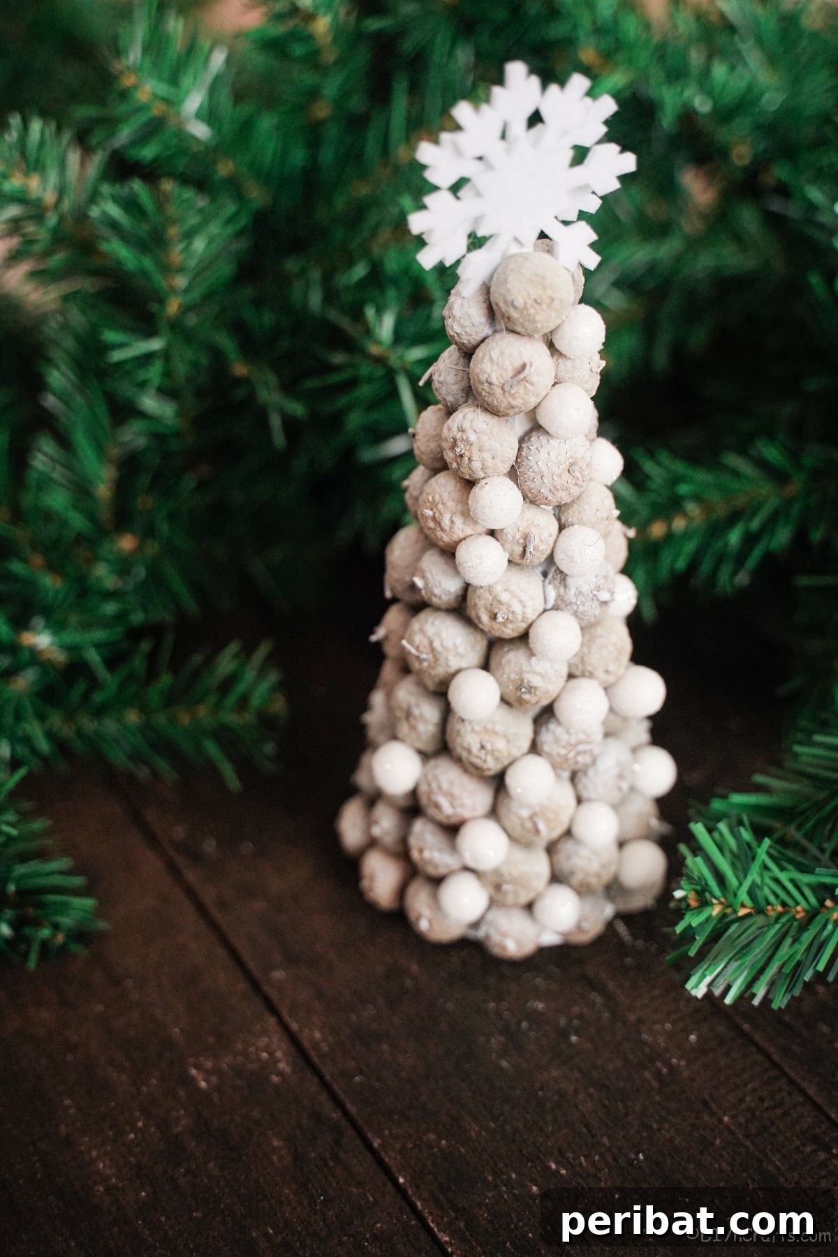 white mini tree on wood table by greenery