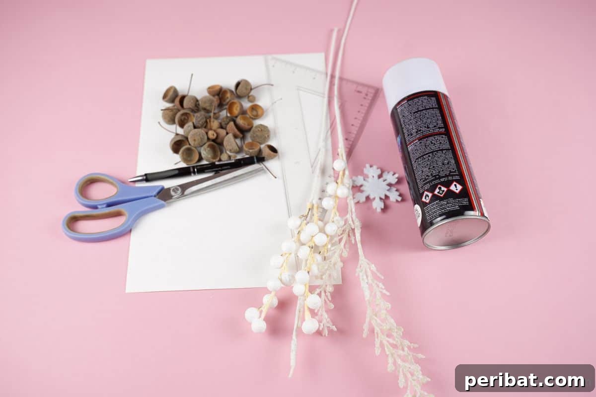 white paper acorns and spray paint on pink paper surface