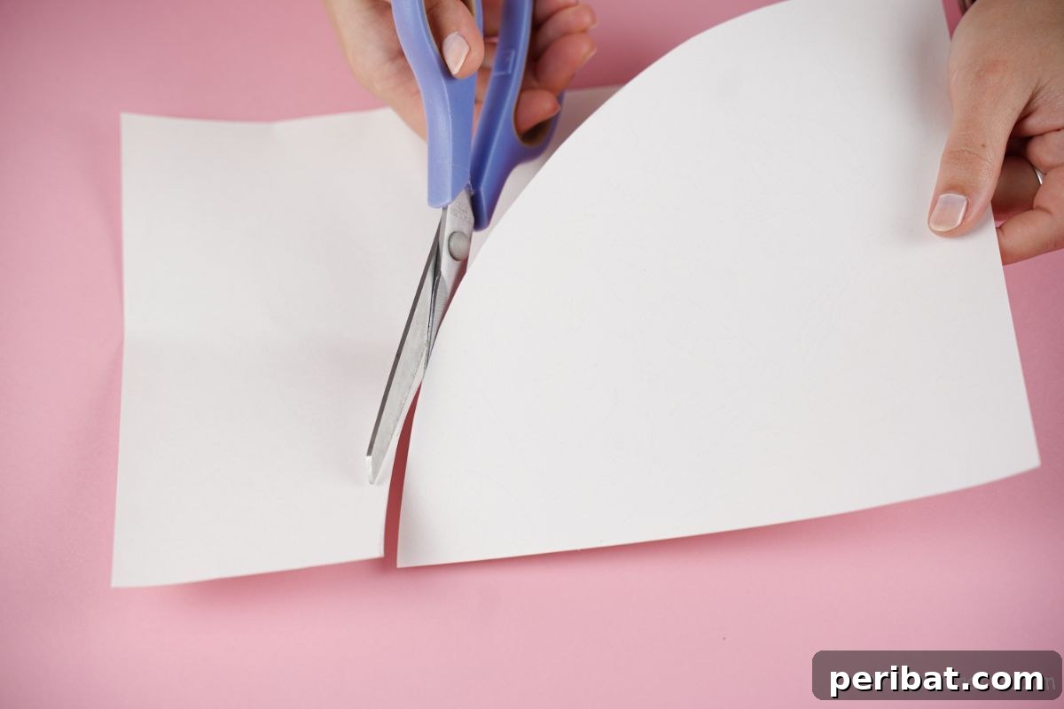 blue scissors cutting white paper