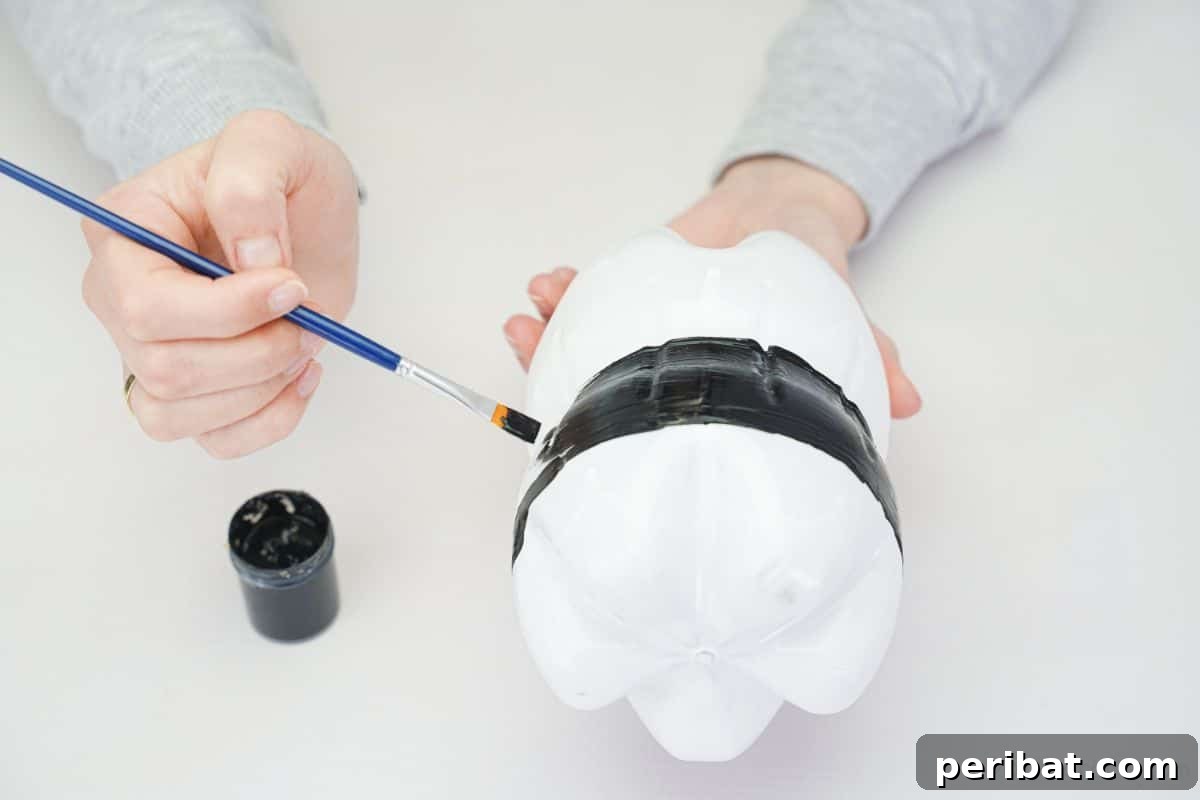 Upcycled Plastic Bottle Penguin Craft for Kids 13 hand drawing and painting on white bottles