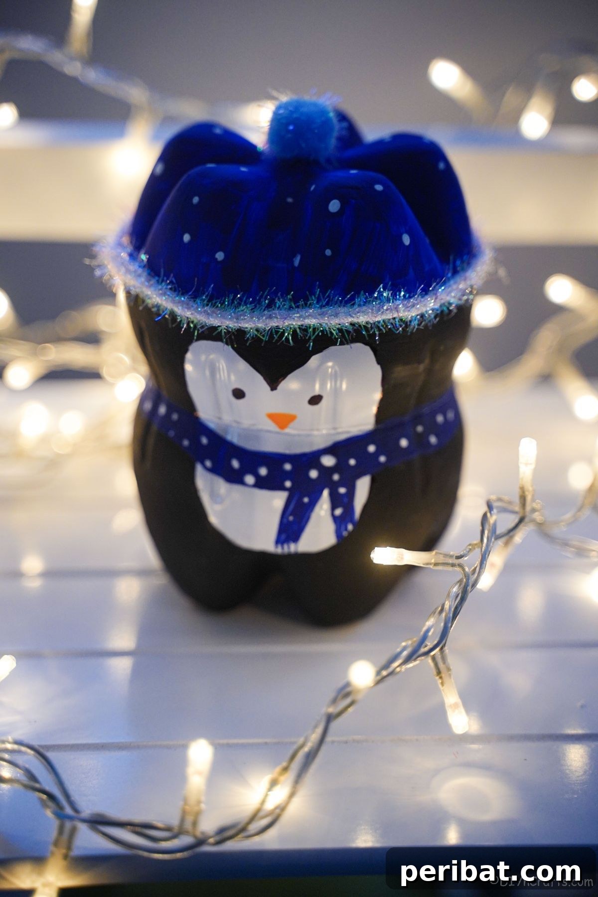 Upcycled Plastic Bottle Penguin Craft for Kids 23 fake penguin craft surrounded by twinkle lights