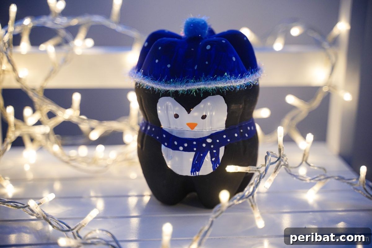Upcycled Plastic Bottle Penguin Craft for Kids 5 black and blue penguin decoration on white table with lights