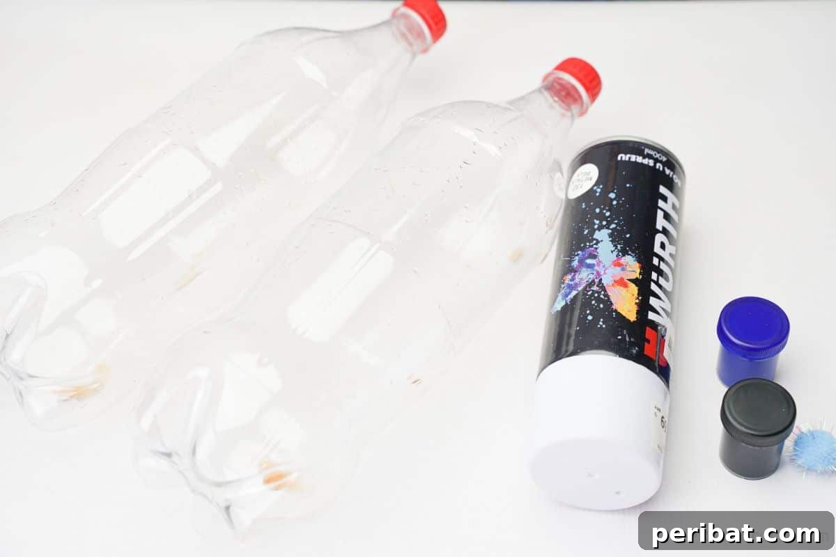 Upcycled Plastic Bottle Penguin Craft for Kids 8 plastic soda bottles white spray paint and craft paint on white table