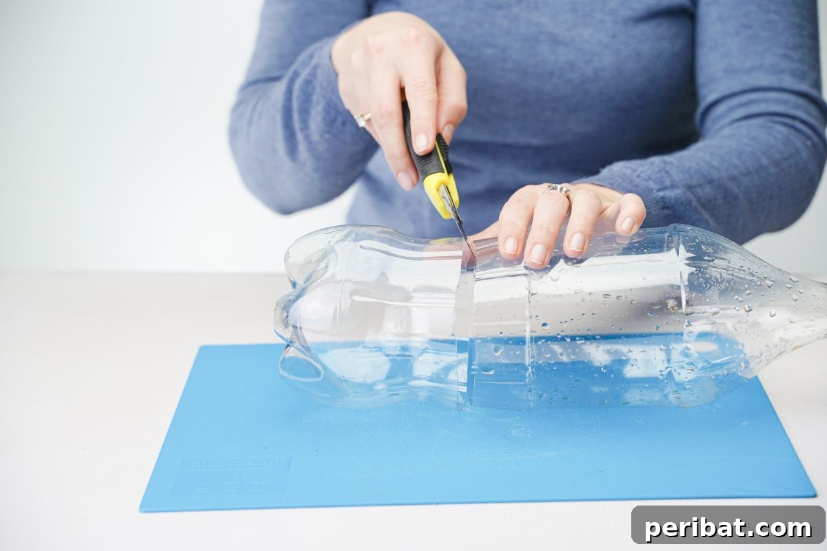 Upcycled Plastic Bottle Penguin Craft for Kids 9 lady using craft knife to cut soda bottle in half
