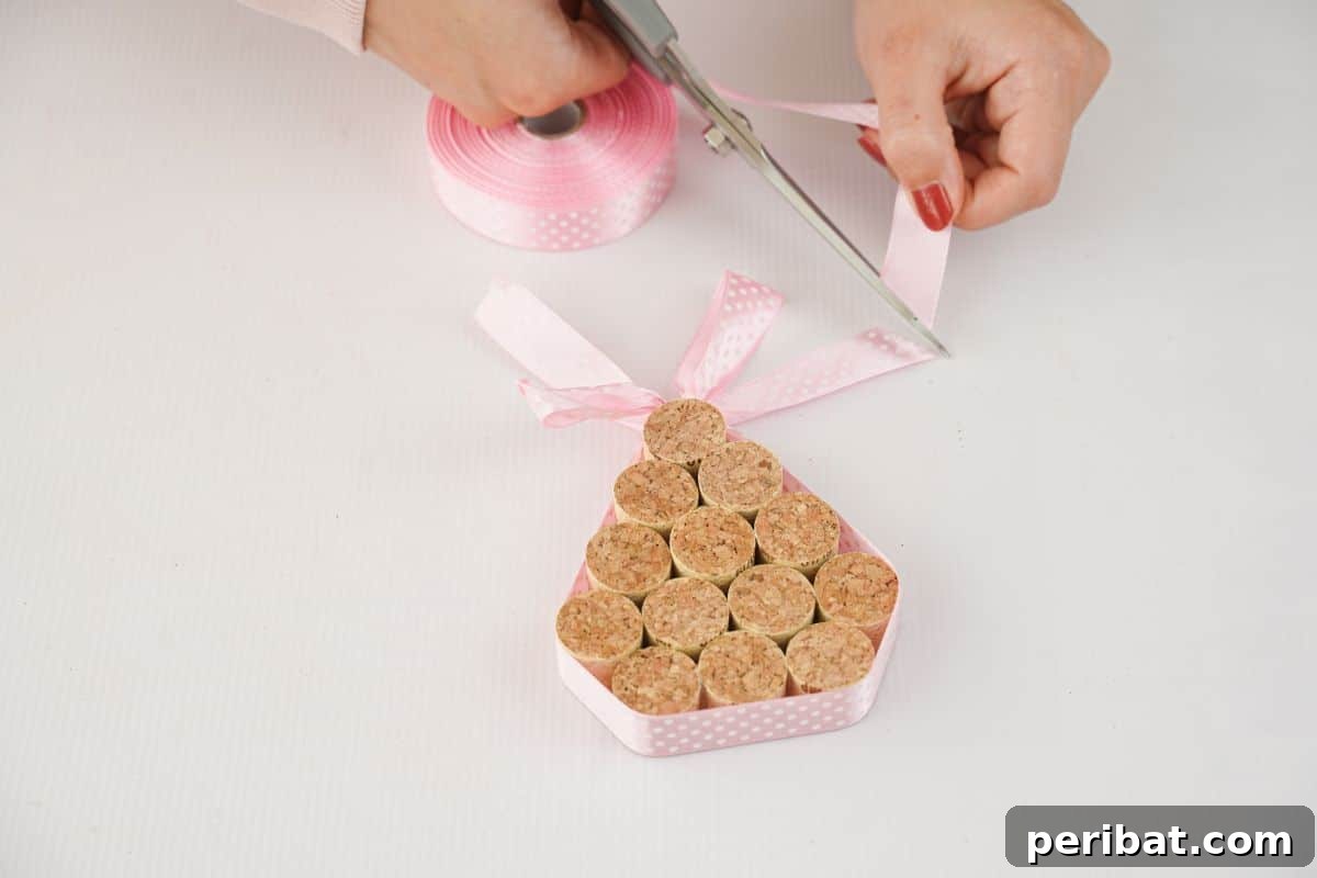 scissors cutting ribbon wrapped around cork tree, adding a decorative touch