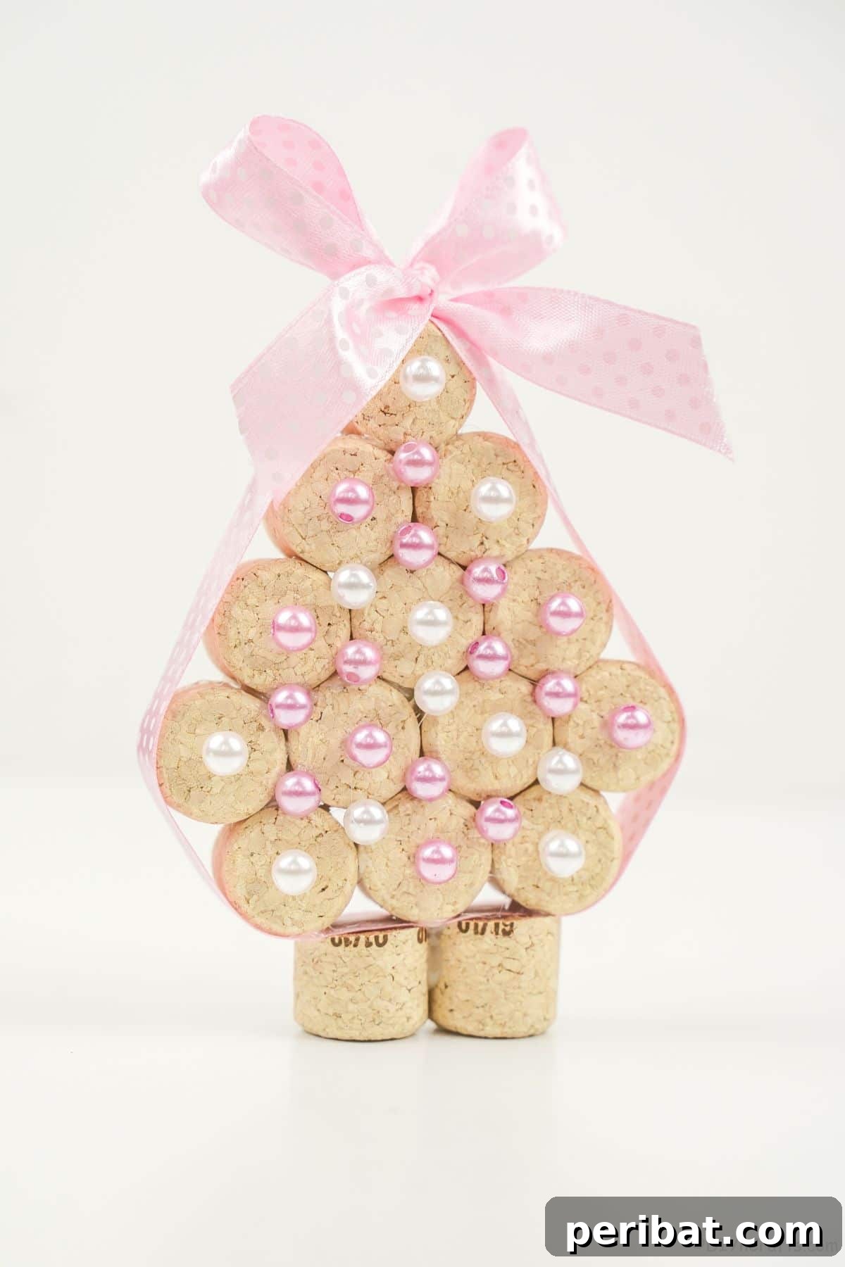 mini christmas tree made of cork on white table