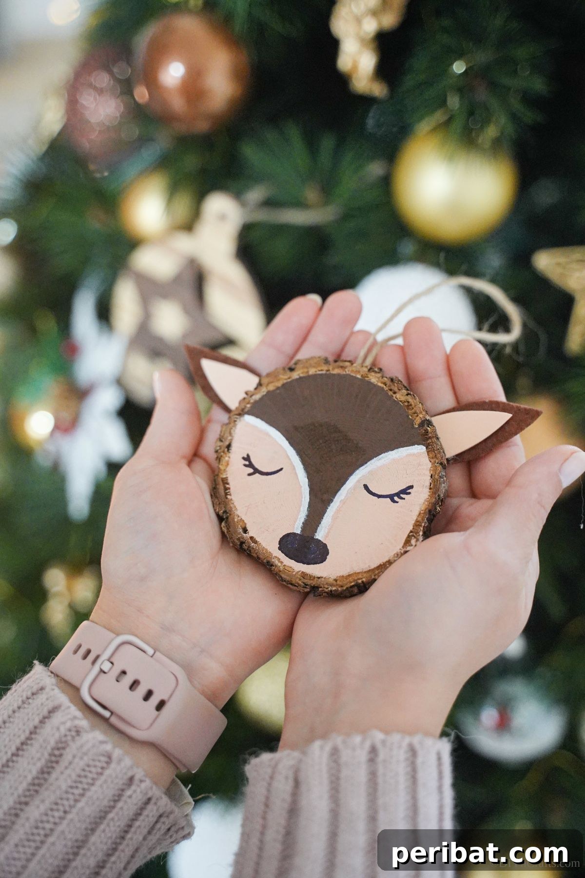 Naturally Charming Reindeer Wood Slice Decor 13 Multiple reindeer ornaments held in a person's hands