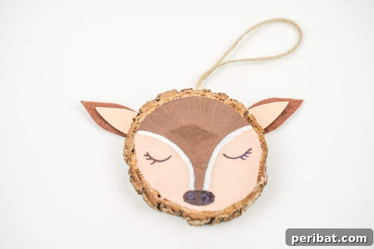 Naturally Charming Reindeer Wood Slice Decor 7 White table displaying a finished wood slice reindeer ornament