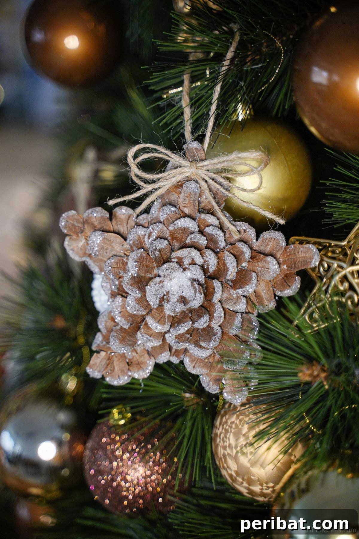 pinecone star ornament on holiday tree with gold ornaments