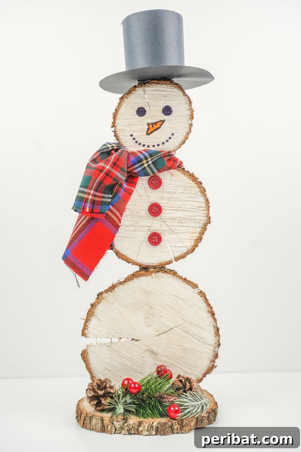 DIY Rustic Wood Slice Snowman Decor 23 A charming wood slice snowman standing proudly on a white table, showcasing the simple elegance of rustic handmade decorations