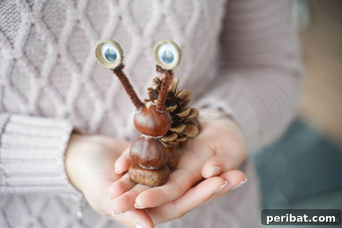 A woman holding the completed pinecone snail, showcasing its charm and handcrafted details.