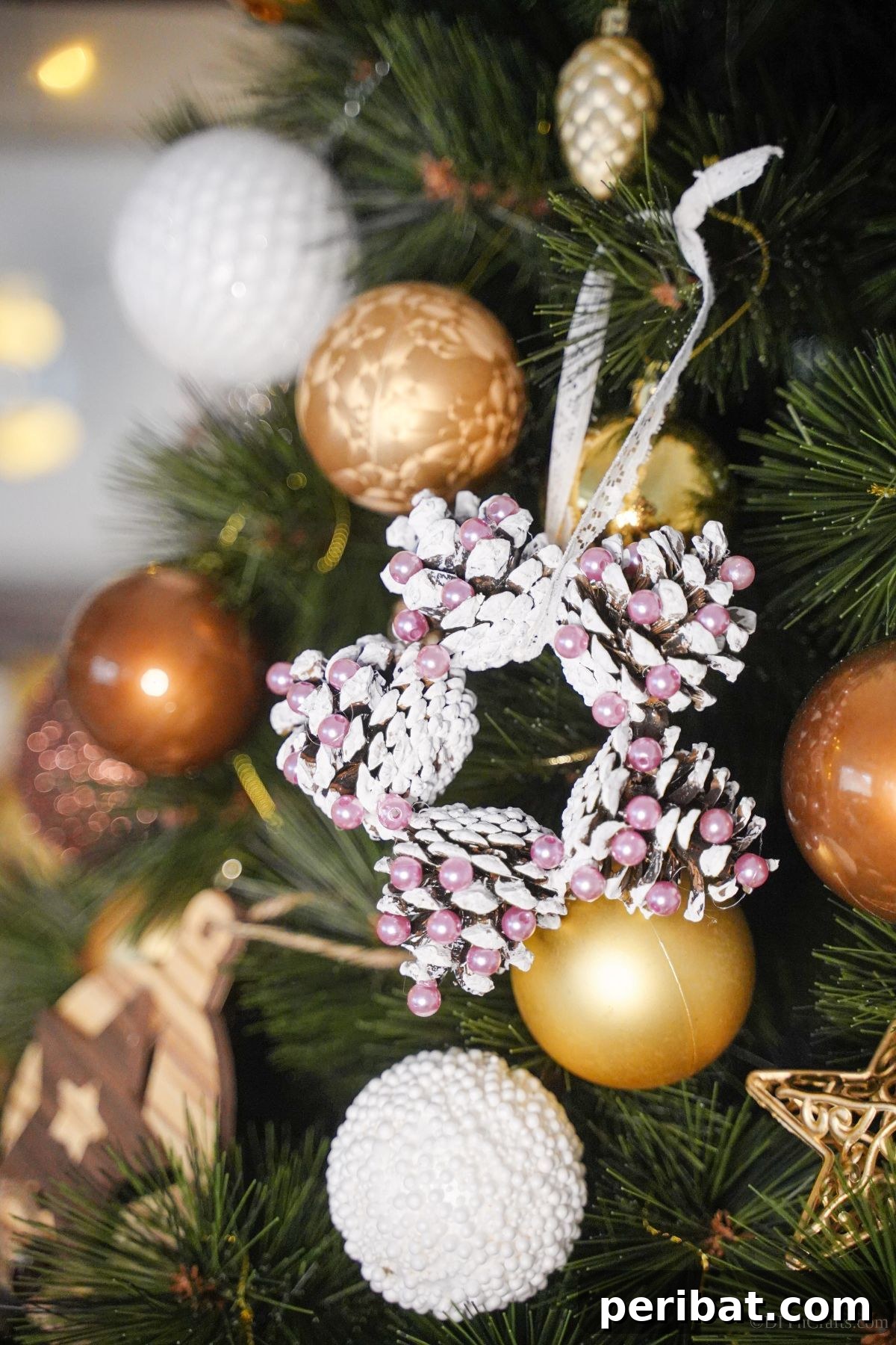 Glistening Bead-Adorned Pinecone Star 2 pinecone star ornament hanging on tree by gold ornaments