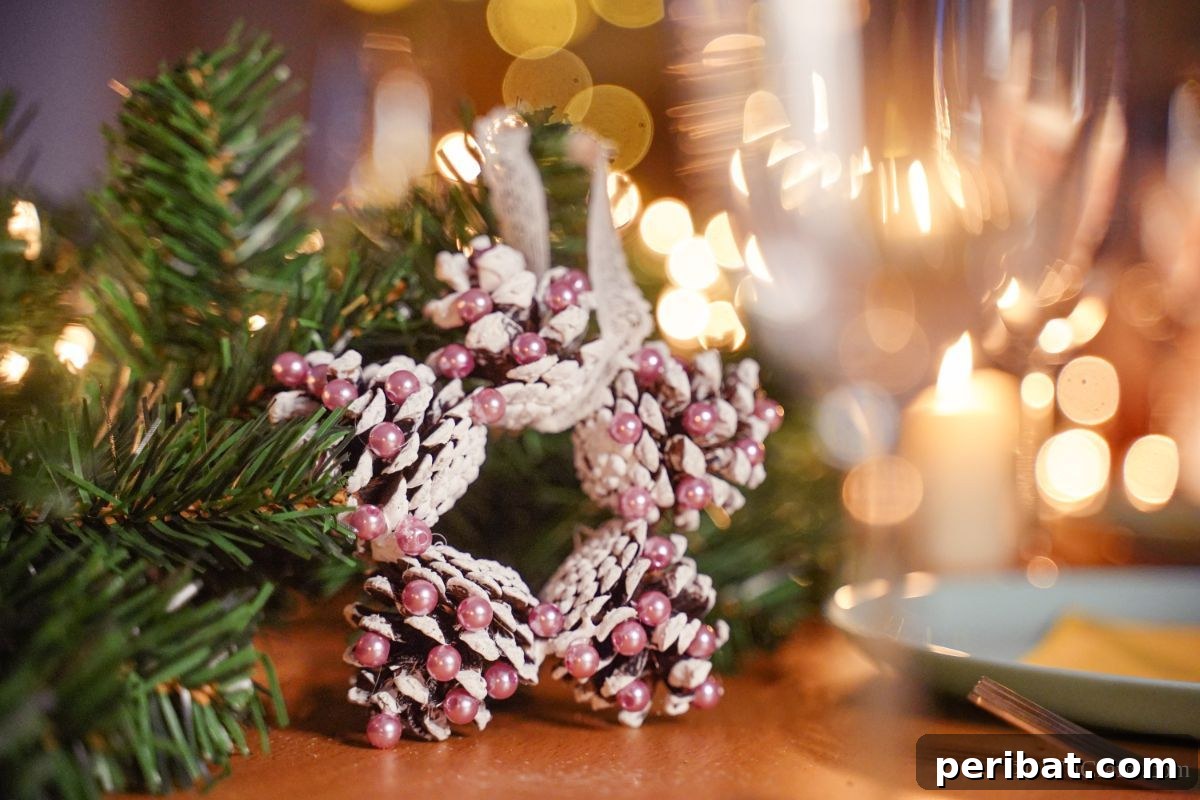 Glistening Bead-Adorned Pinecone Star 3 pink and white star ornament made from pinecones on table by place setting