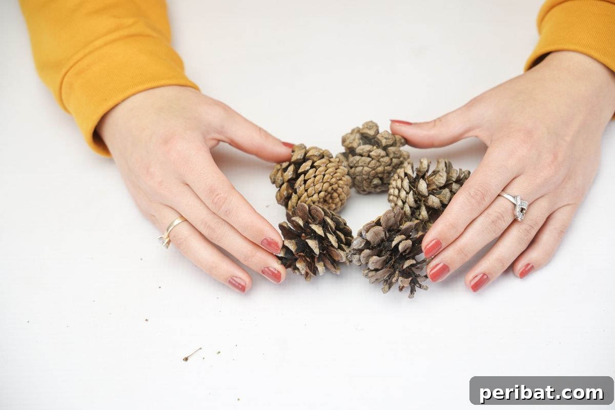 Glistening Bead-Adorned Pinecone Star 8 hand holding pinecones together in shape of a star