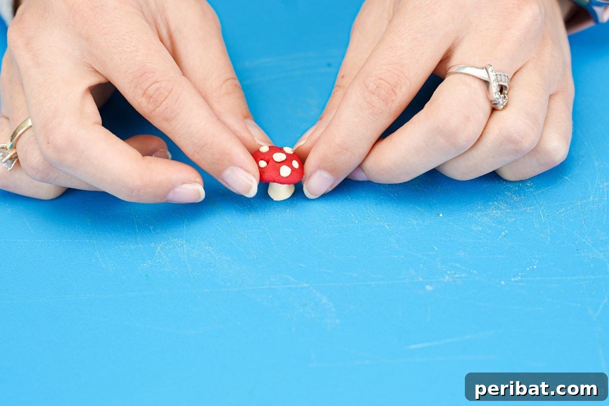 hand putting red top on white mushroom stalk