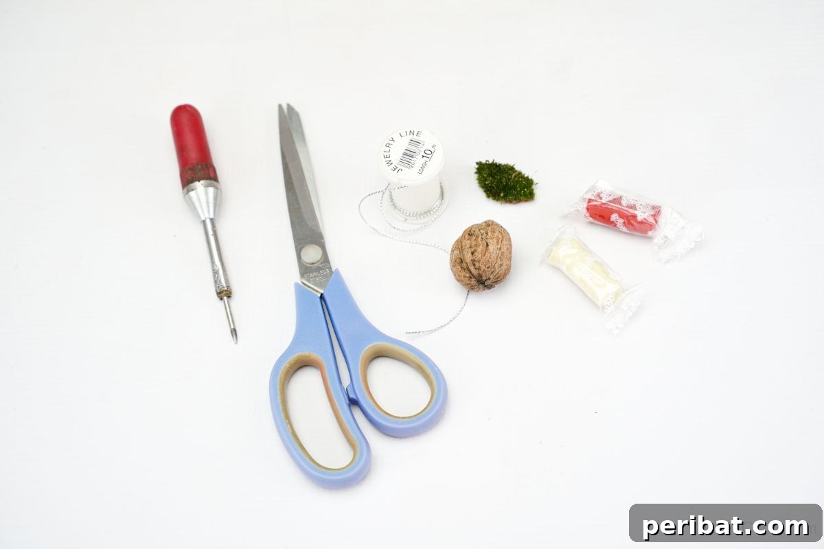 Crafting supplies including scissors, a walnut shell, string, and modeling clay neatly arranged on a white table, ready for the DIY ornament project.