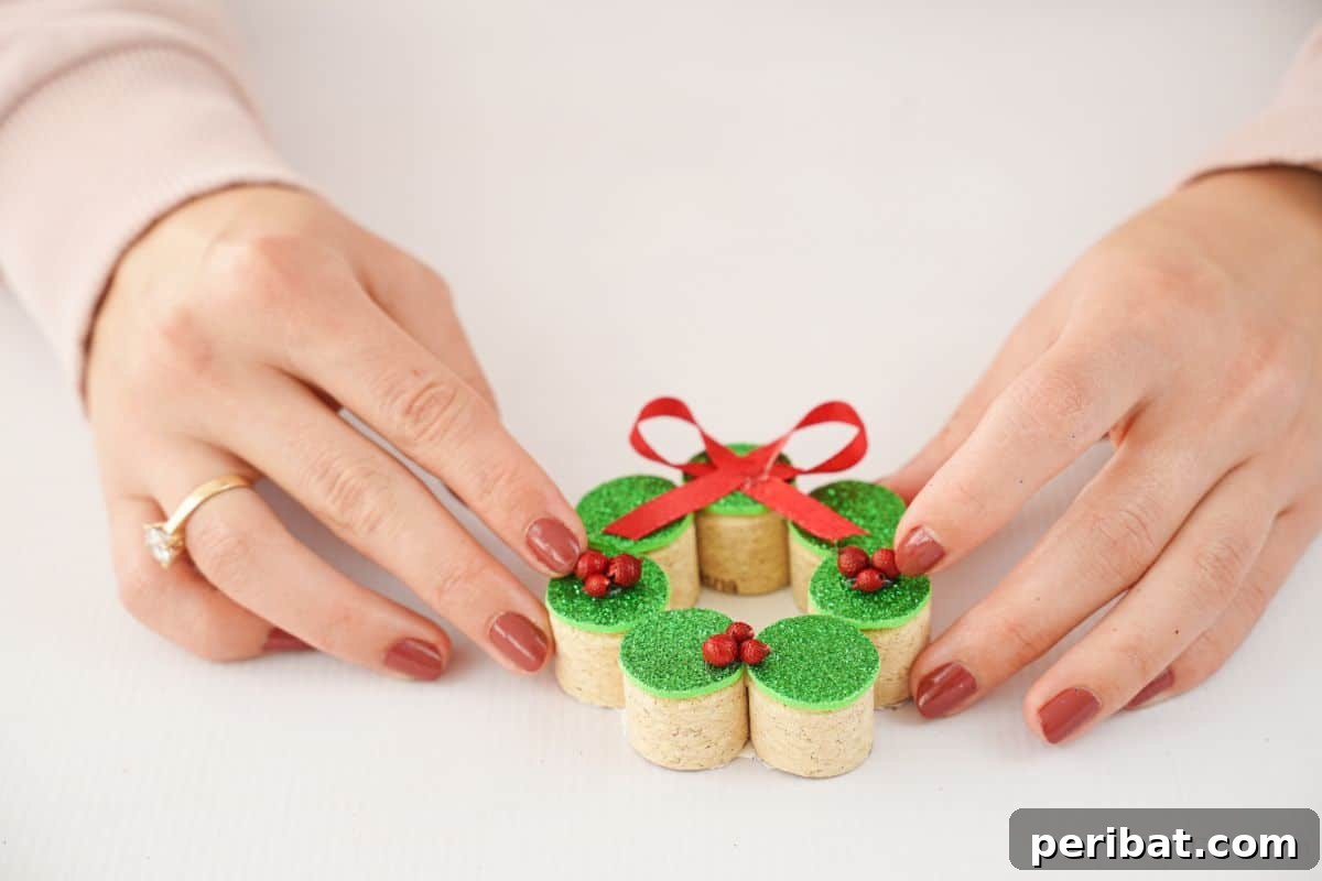 Repurposed Cork Wreath Charm 11 Hand carefully placing red beads onto the green top of a cork ornament to resemble berries