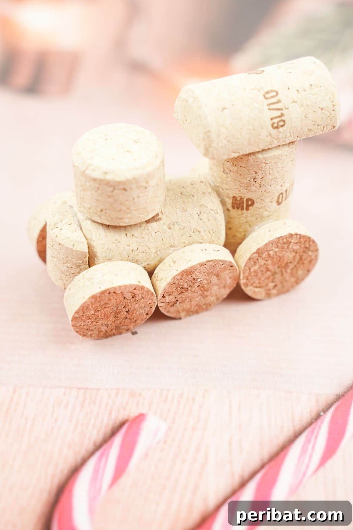 Wine Cork Express Christmas Ornament 4 A beautifully crafted wine cork train ornament resting on festive, holiday-themed paper