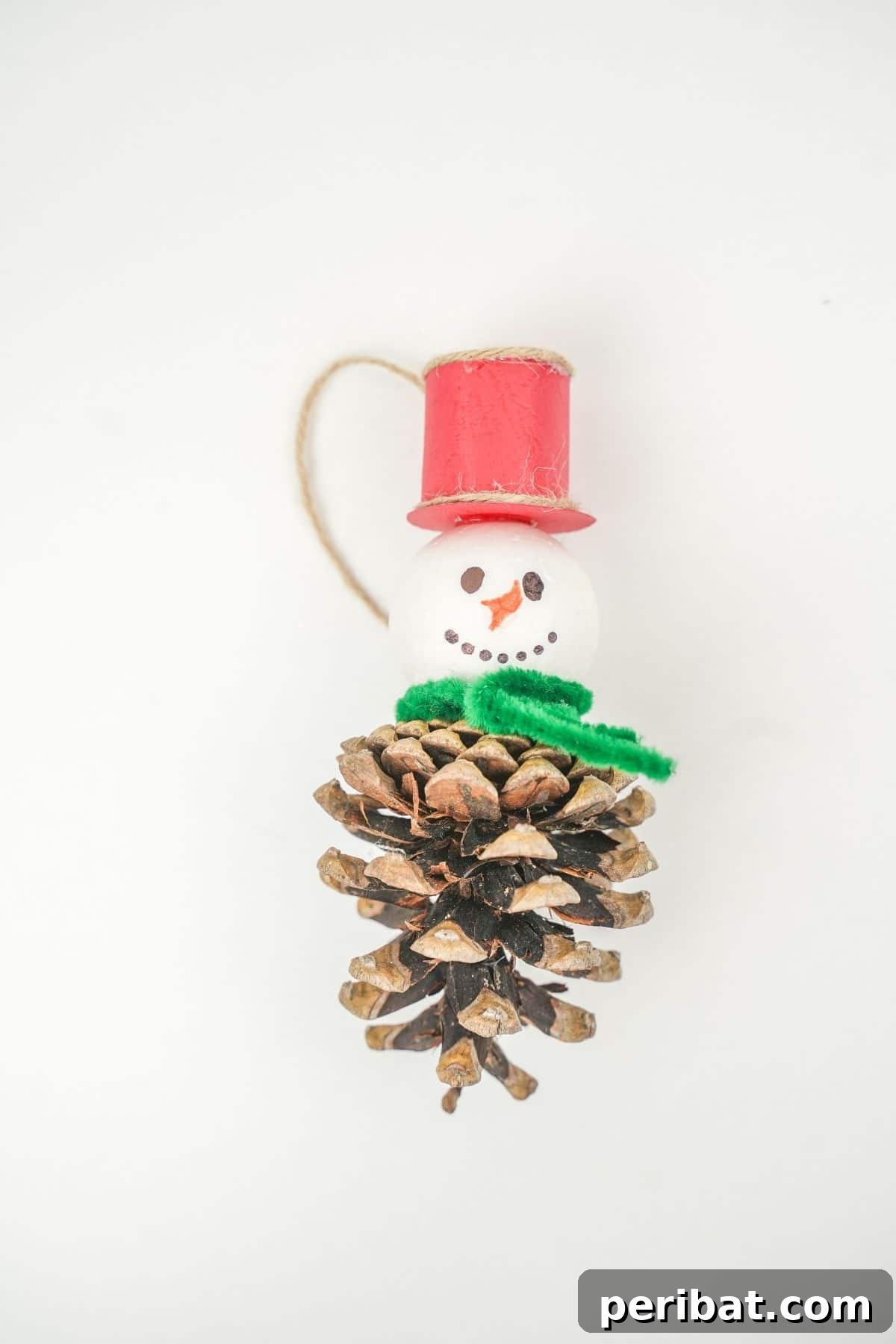 Woodland Pinecone Snowman Charm 16 pinecone snowman ornament on white table