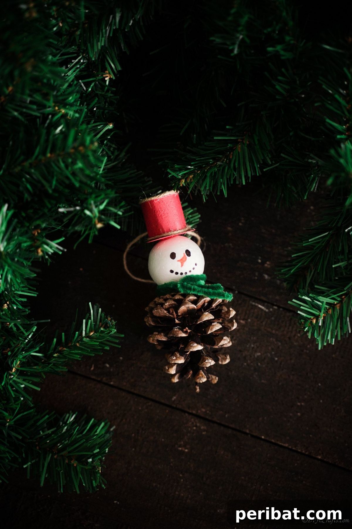 Woodland Pinecone Snowman Charm 5 pinecone snowman laying on black table