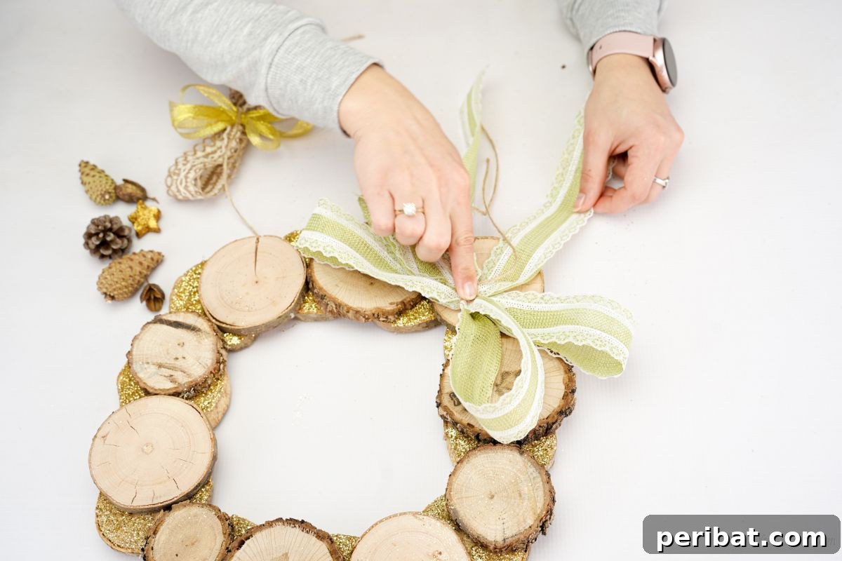 Natural Branch Slice Wreath Adorned with Pinecones 16 Gluing the large green bow onto the edge of the wood slice wreath