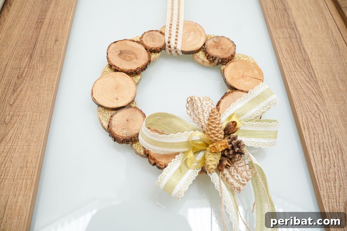 Natural Branch Slice Wreath Adorned with Pinecones 21 View looking up at a wood wreath on a glass panel door