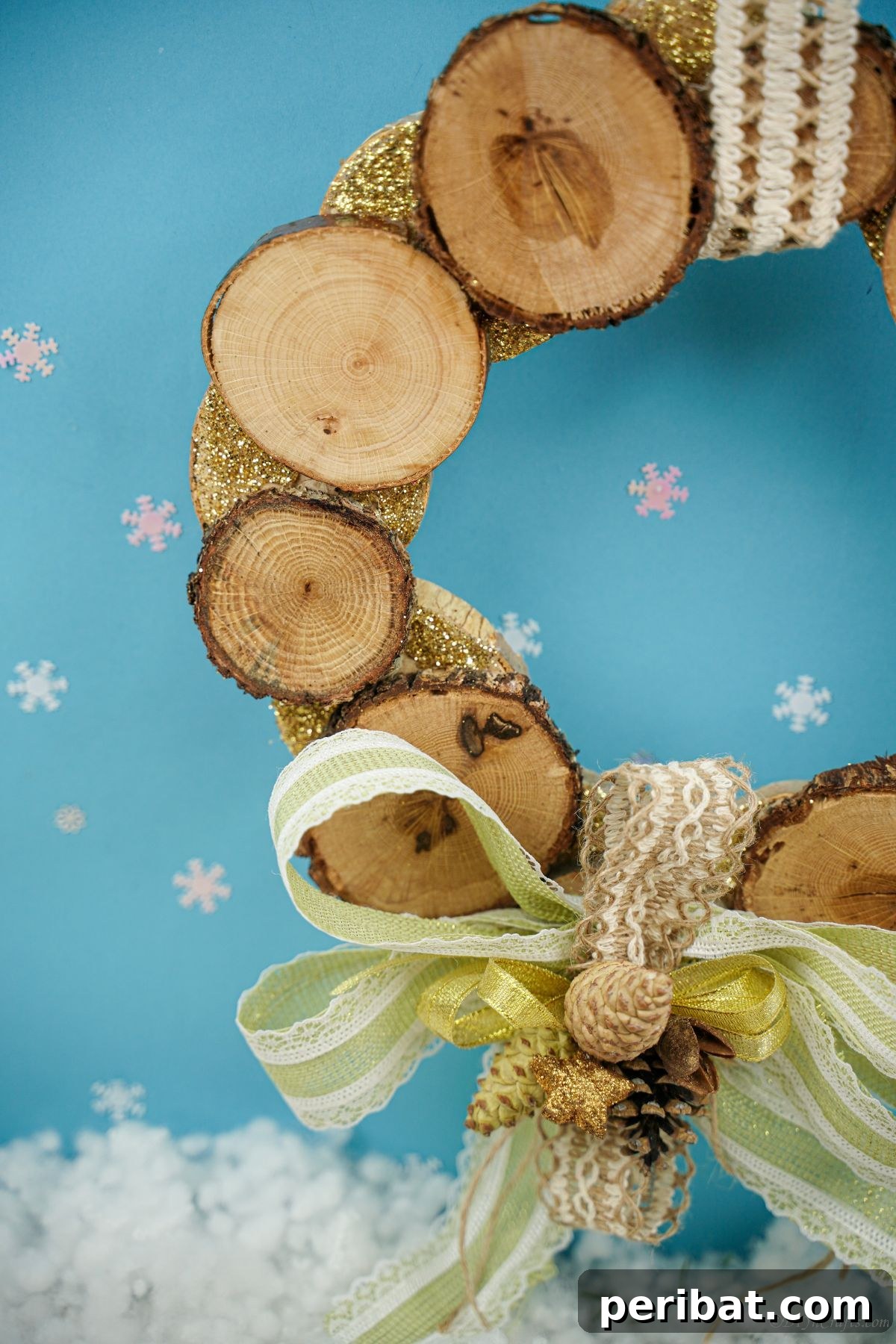 Natural Branch Slice Wreath Adorned with Pinecones 20 Side view of wreath with wood slice and green bow on blue background