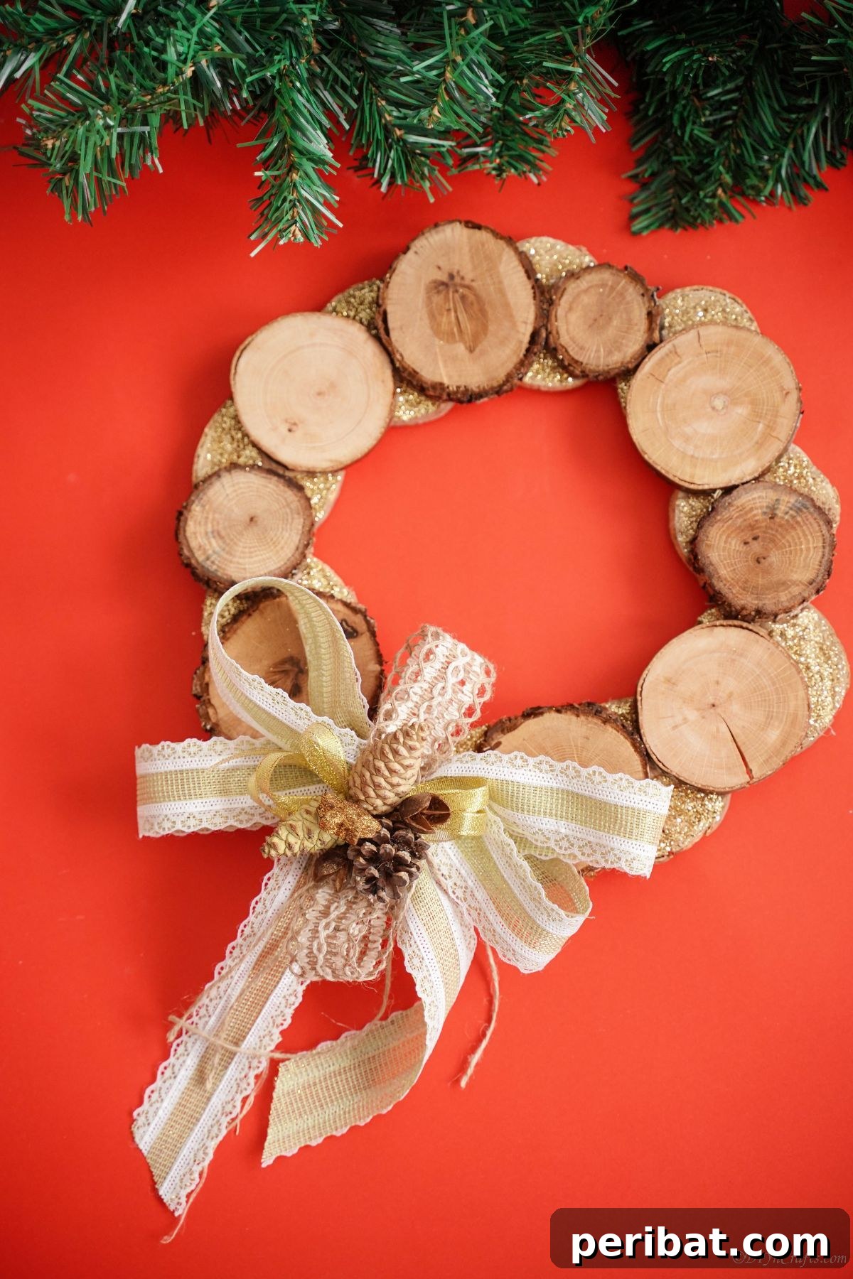Natural Branch Slice Wreath Adorned with Pinecones 4 Wood slice wreath with green pine branches against a red background