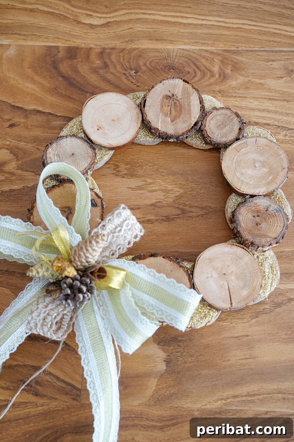 Natural Branch Slice Wreath Adorned with Pinecones 5 Wood slice wreath adorned with pinecones and ribbon on a wooden table