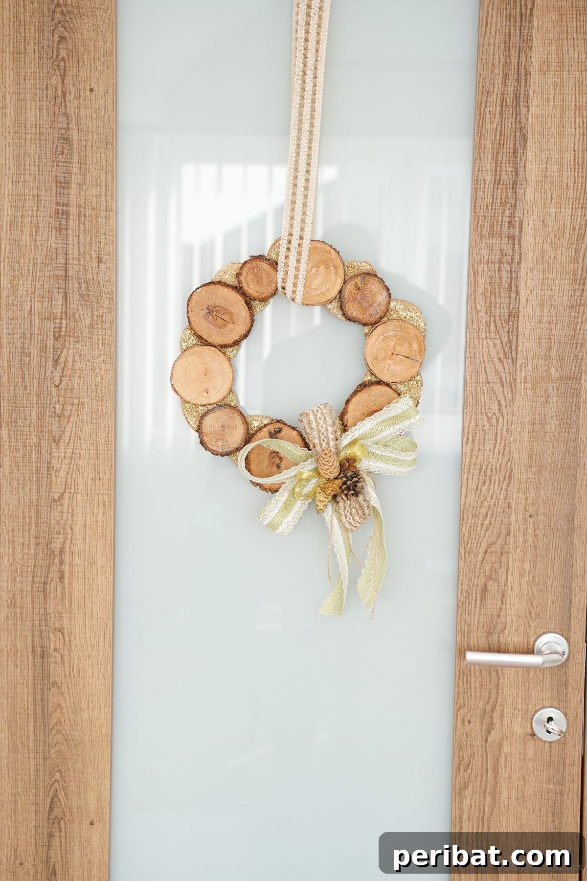 Natural Branch Slice Wreath Adorned with Pinecones 6 Wood slice wreath hanging on a glass door with wooden frames