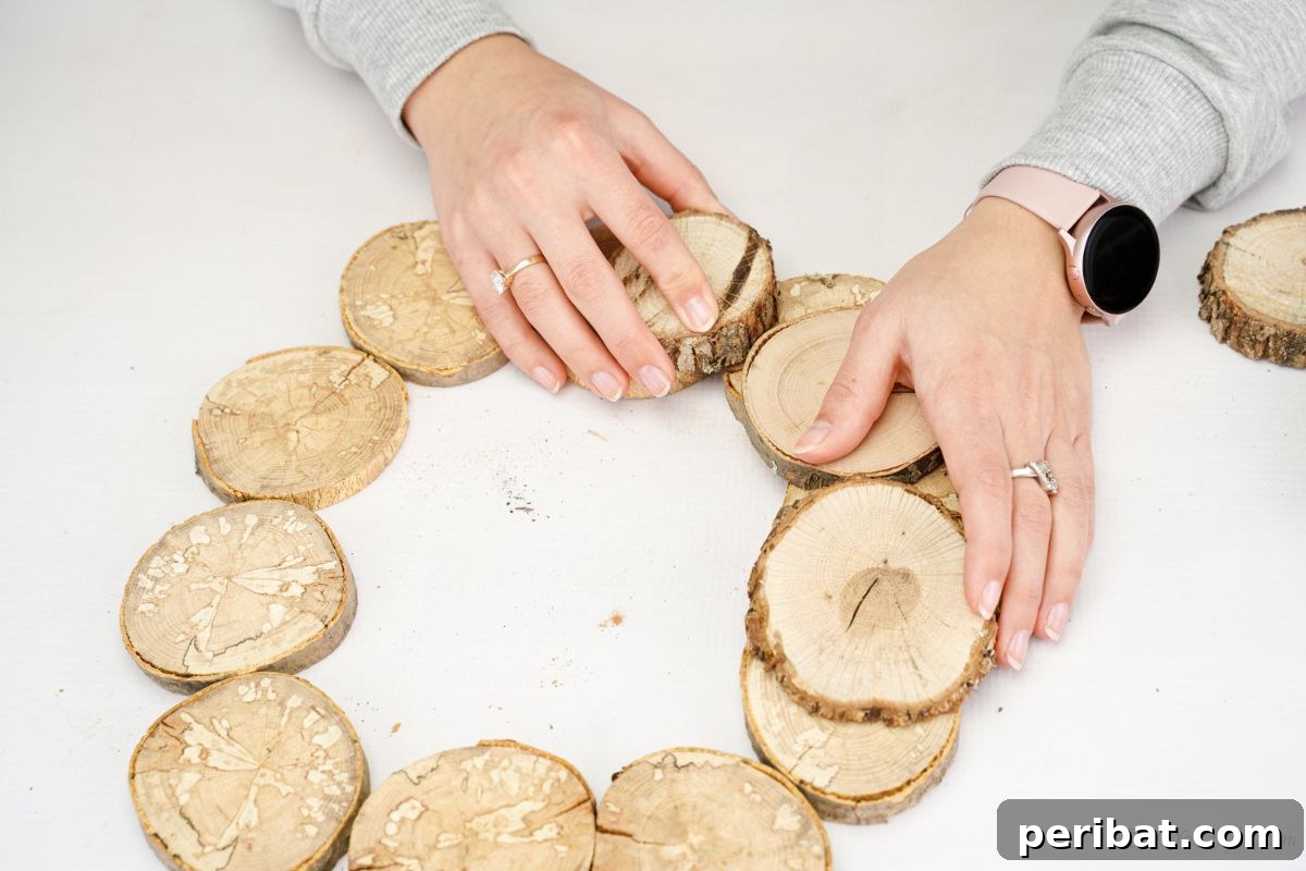 Natural Branch Slice Wreath Adorned with Pinecones 10 More wood slices being glued onto the initial circle, creating overlapping layers