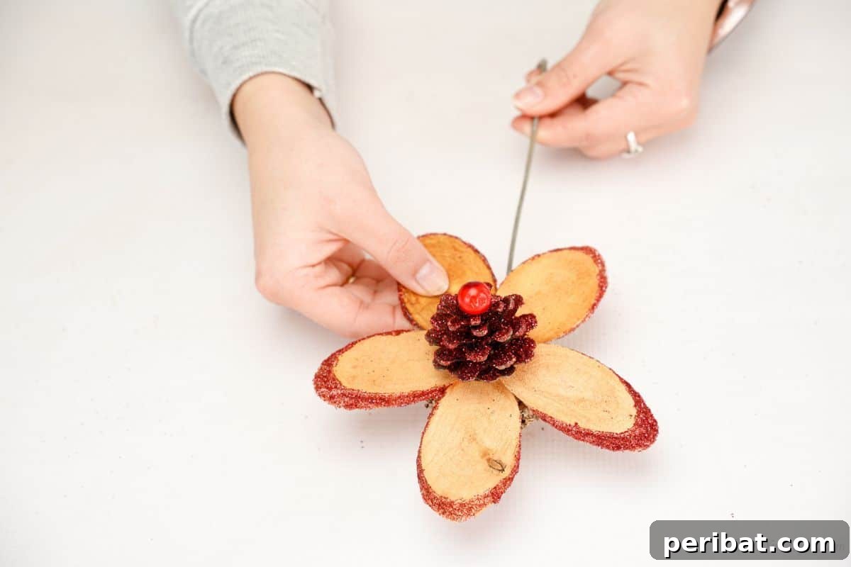 hand holding wood slice flower by stem
