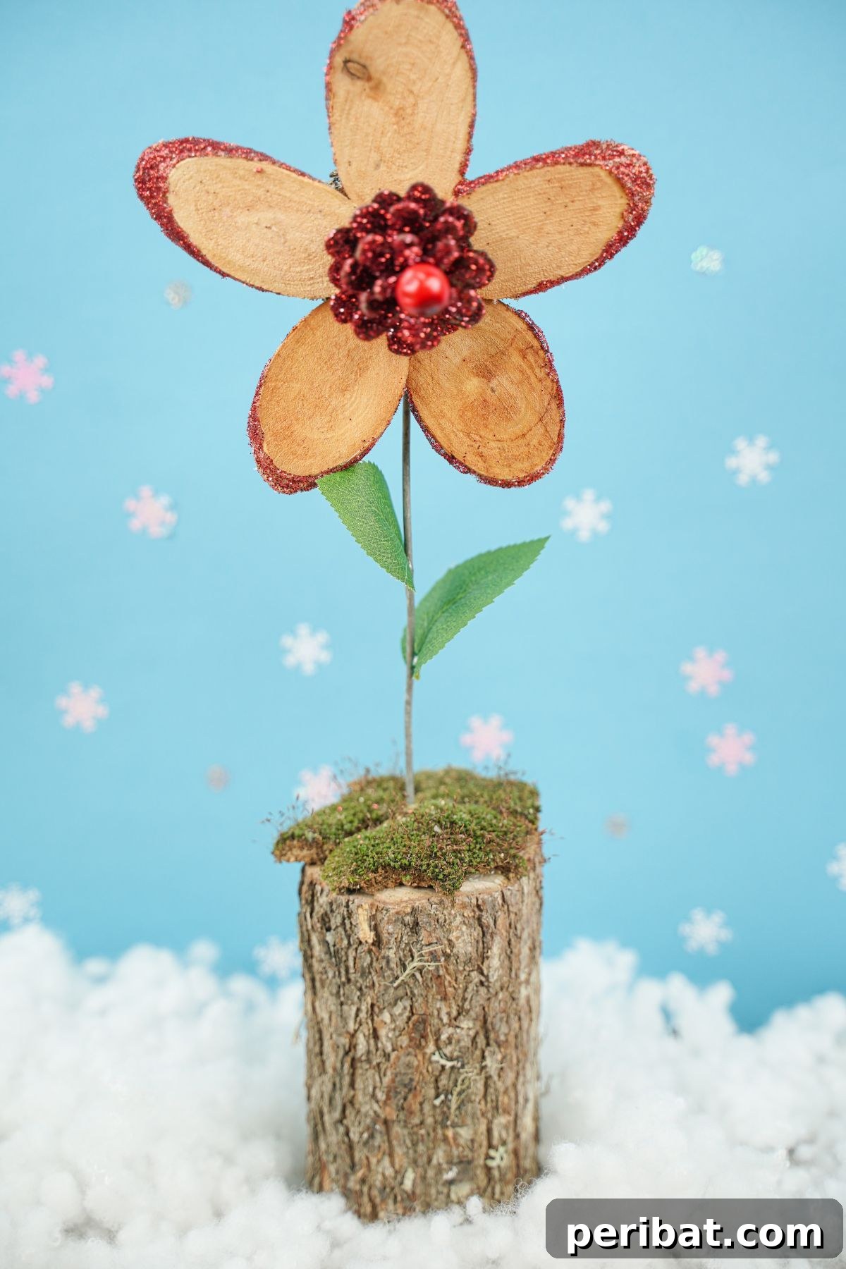 wood flower on wood stump on fake snow
