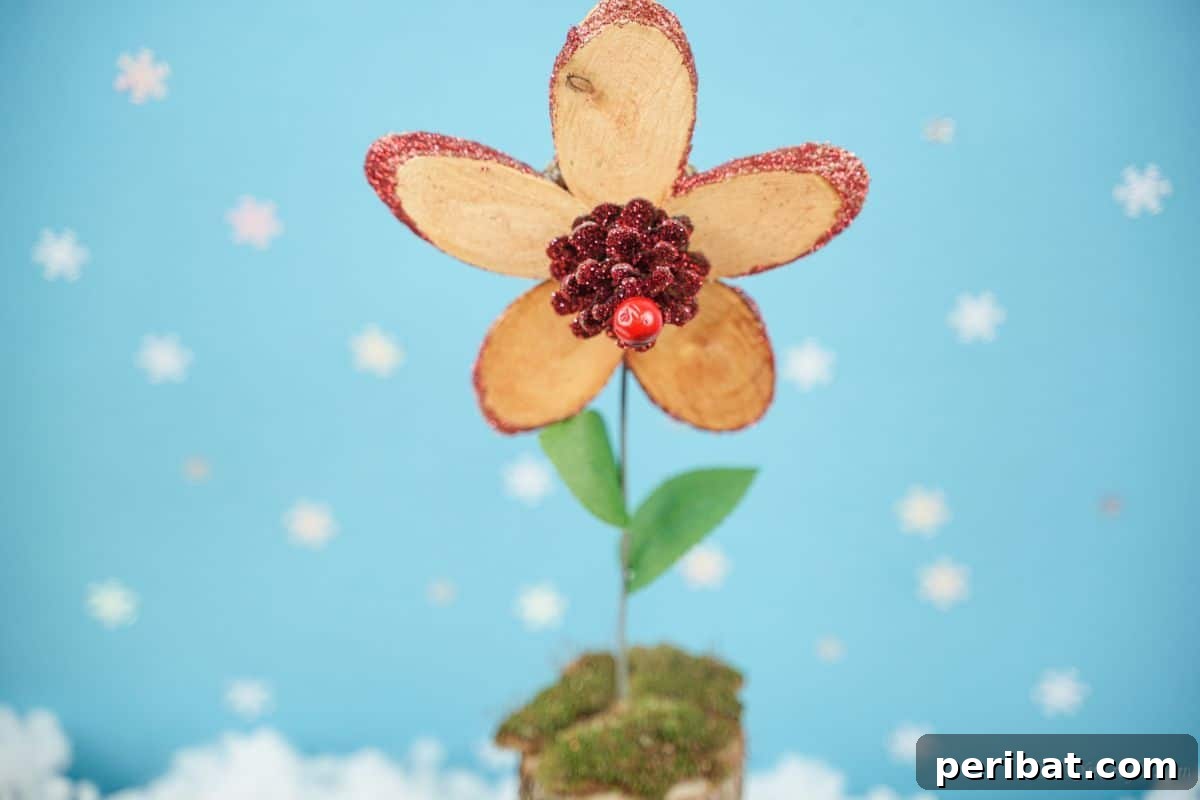 close up image of wood slice flower against blue and white background