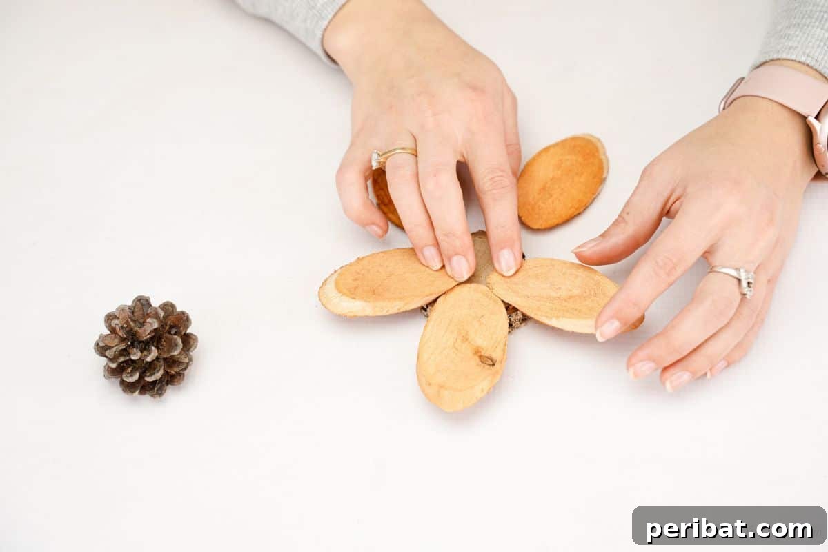 hand holding wood slices on top of round wood slice