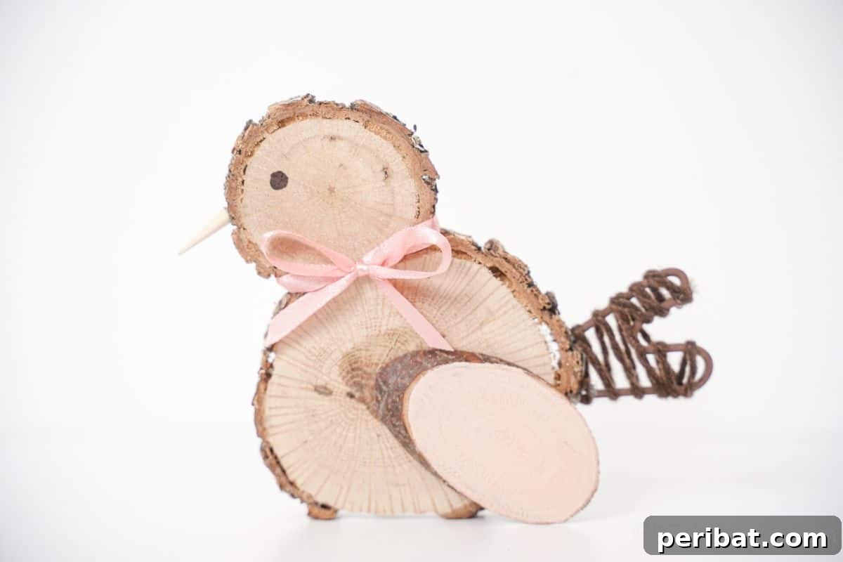 pink ribbon bow on a cute wood slice chick sitting on a white table