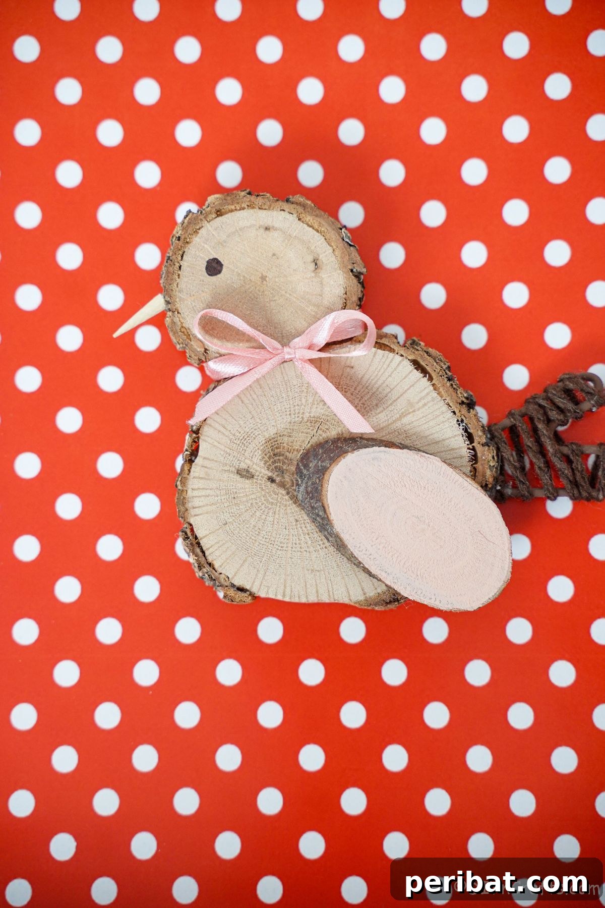 red and white polka dot paper as a vibrant background for a wood slice chick