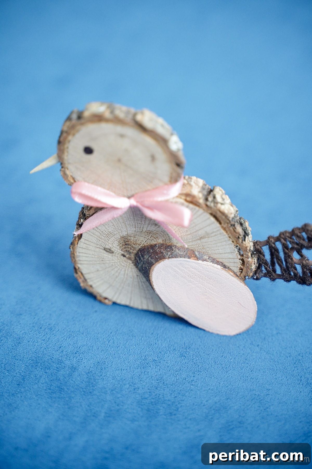 blue table underneath a rustic wood slice chick, highlighting its simplicity