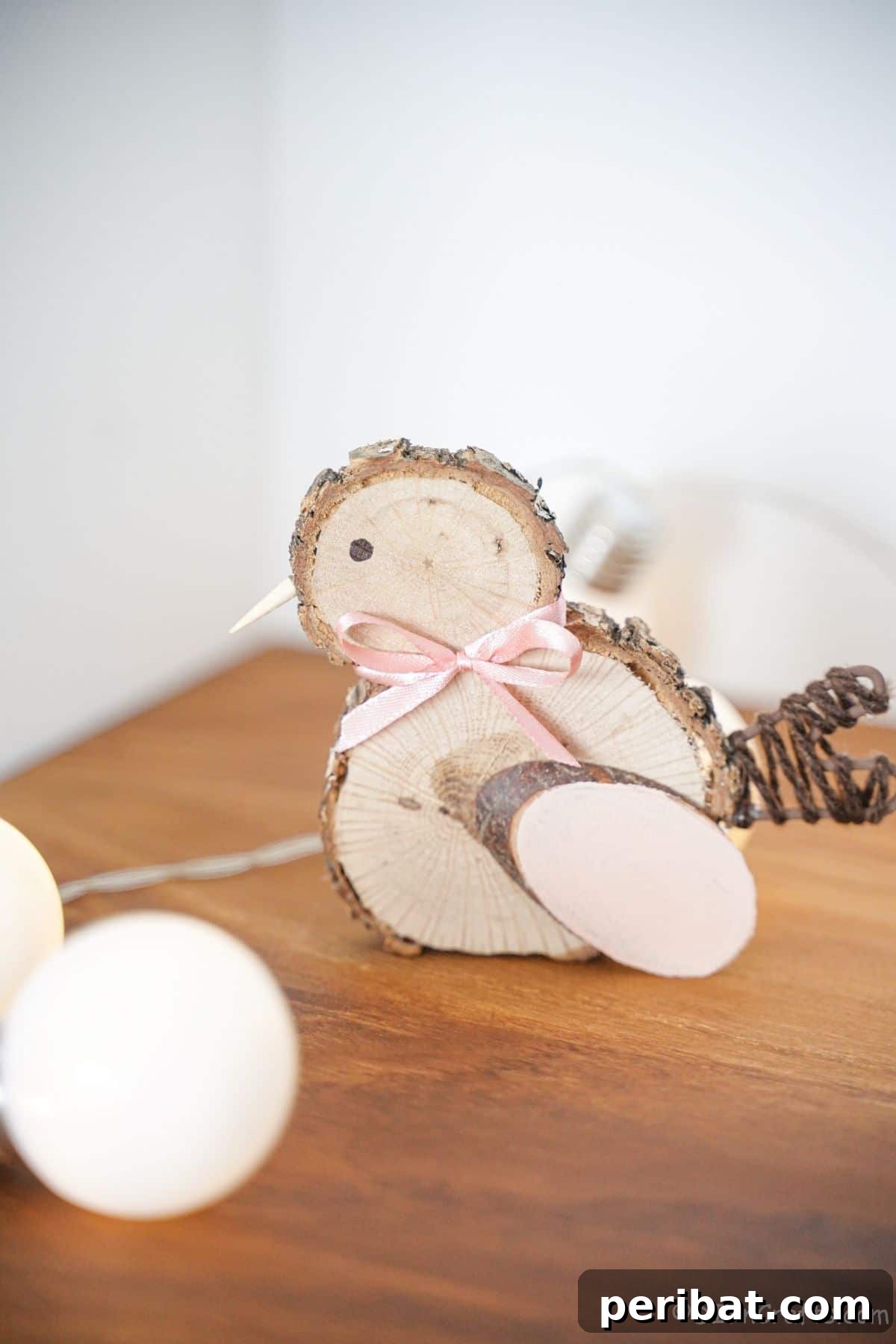 wood slice chicken with a pink bow on a table adorned with soft lights, creating a warm ambiance