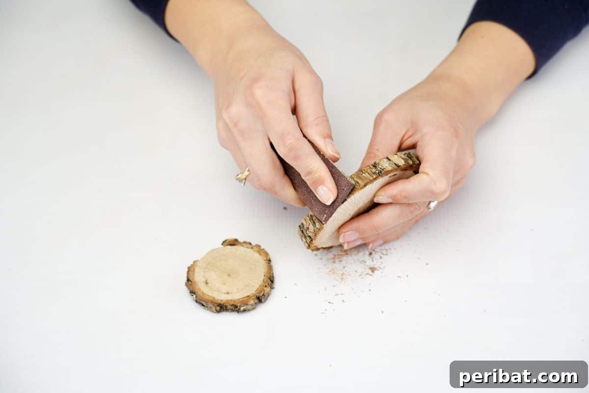 hand sanding wood slices to prepare for crafting