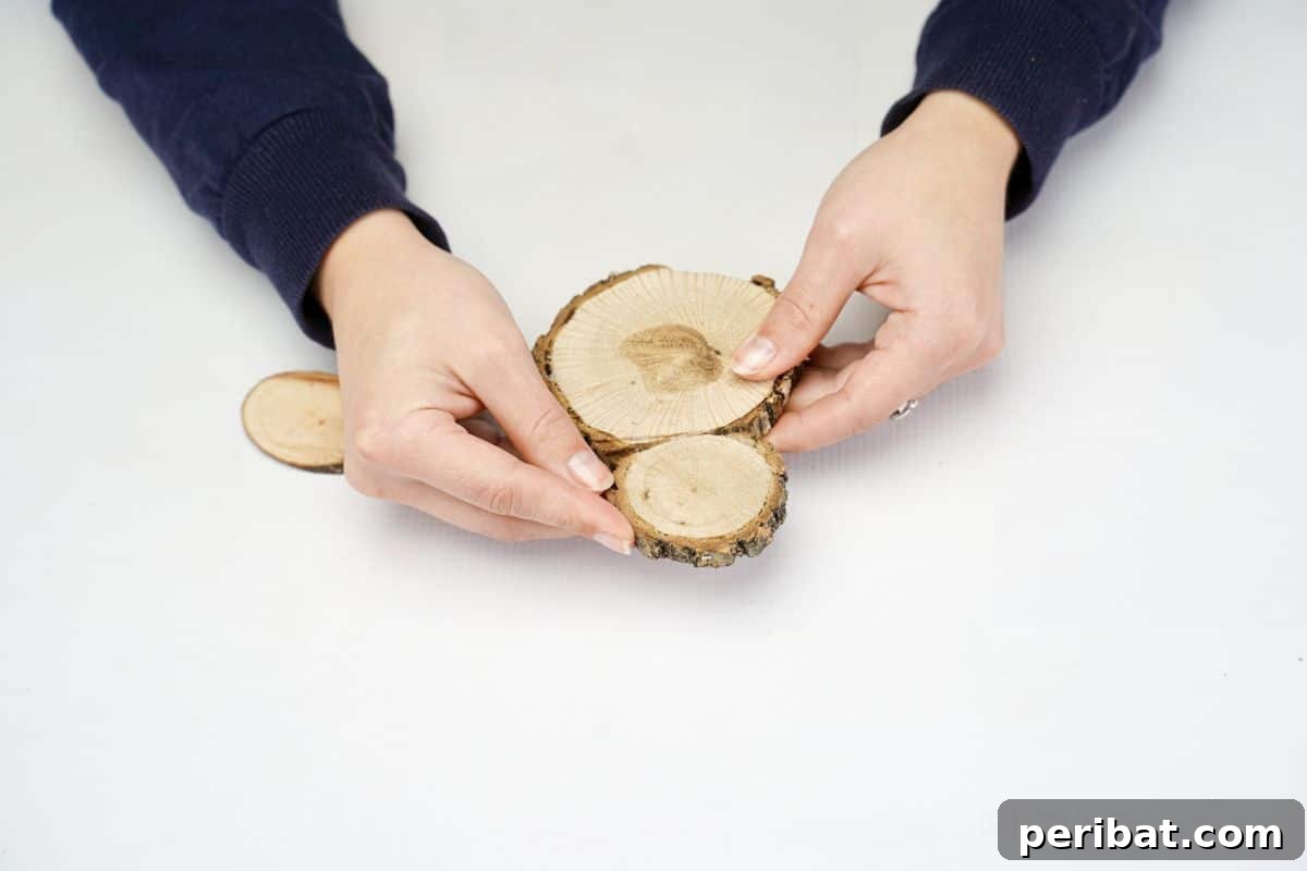 hand gluing two wood slices together to form the chicken's body and head